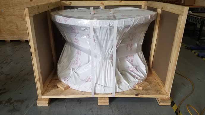Machine part vacuum wrapped in a shipping crate