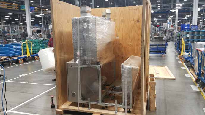 Machine bubble wrapped in crate