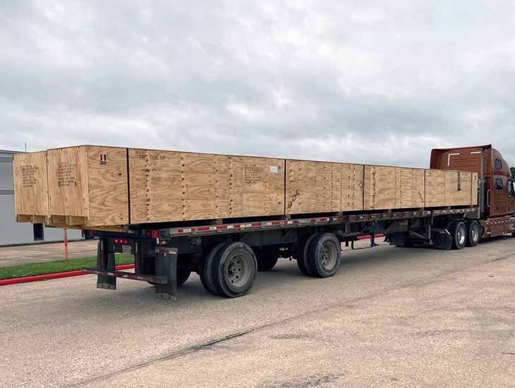 Long crate on flatbed truck