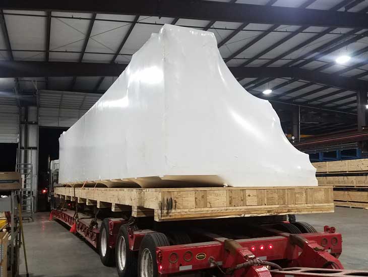 Long electrical cabinet vacuumed wrap on flatbed truck