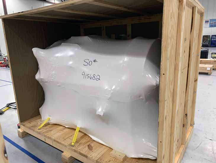 Vacuum wrapped part in crate